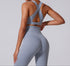 Back view of gray workout set showing X-back sports bra design and high-waisted leggings