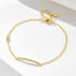 Gold bar bracelet with CZ stones on a white background.