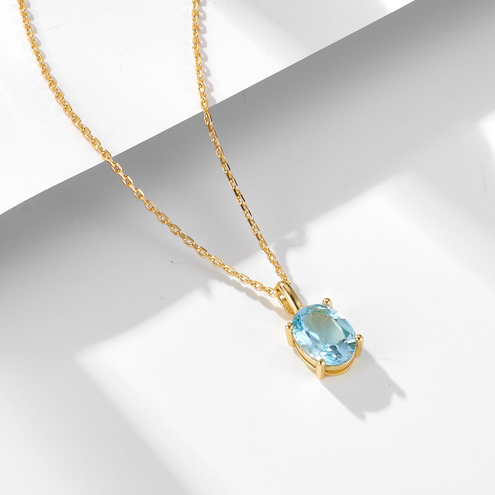 Elegant blue topaz necklace in gold-plated silver with classic prong setting.