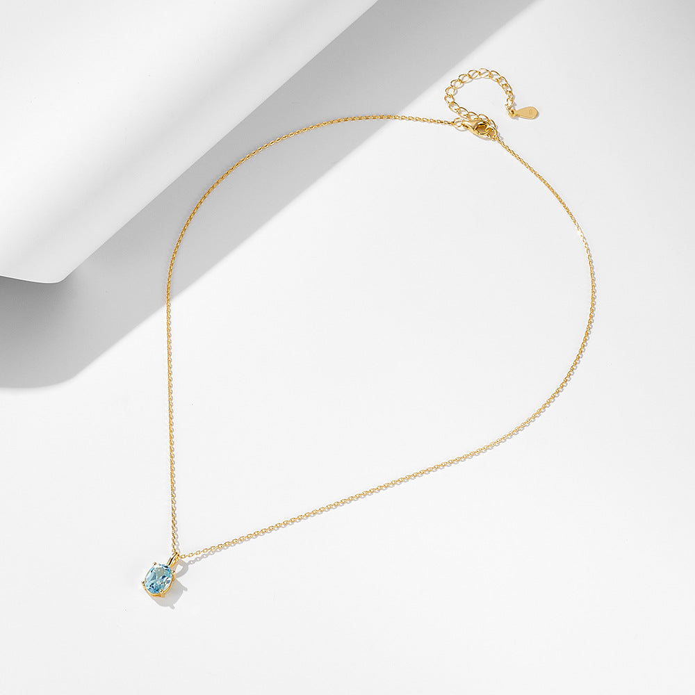 Minimalist S925 chain necklace with oval blue topaz pendant and extender.