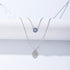 Silver double-layer necklace with blue evil eye charm and Hamsa hand pendant