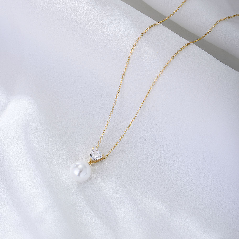 Gold-plated sterling silver necklace with heart-cut CZ and white pearl pendant.