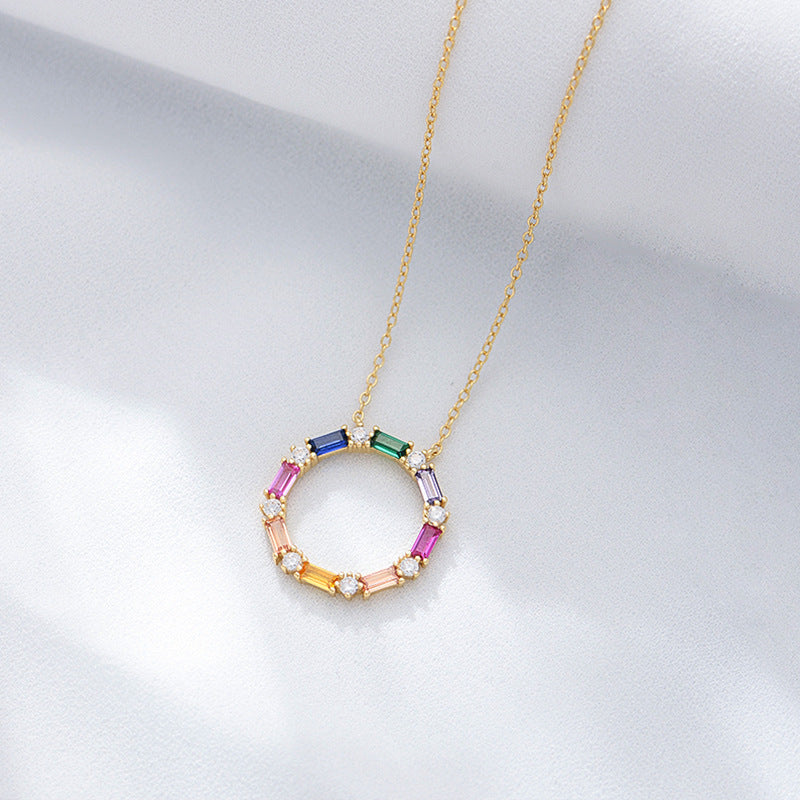 S925 Gold-plated sterling silver circle necklace with rainbow baguette CZ stones on satin.