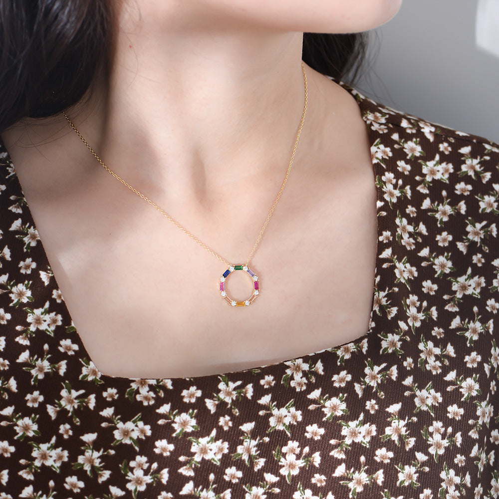 Woman wearing S925 Rainbow CZ Circle Necklace with floral print top.