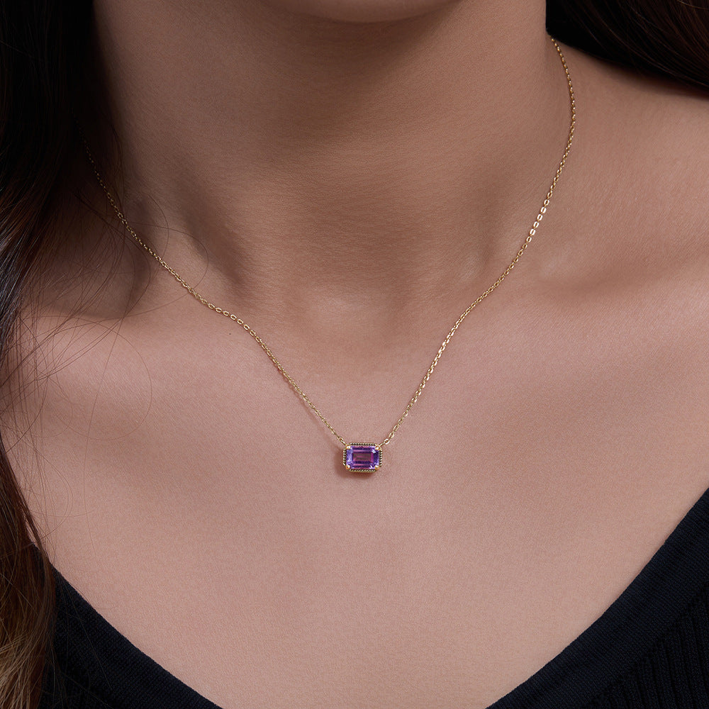Woman wearing gold-plated S925 necklace with emerald-cut amethyst pendant.