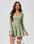 The sage green long-sleeve tennis dress features a wrap-front design, a collared V-neck, and a pleated skirt, making it perfect for activewear