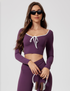 Purple workout set with long sleeve crop top and leggings, featuring white trim and front tie detail, styled with headphones and sunglasses, style CX2942