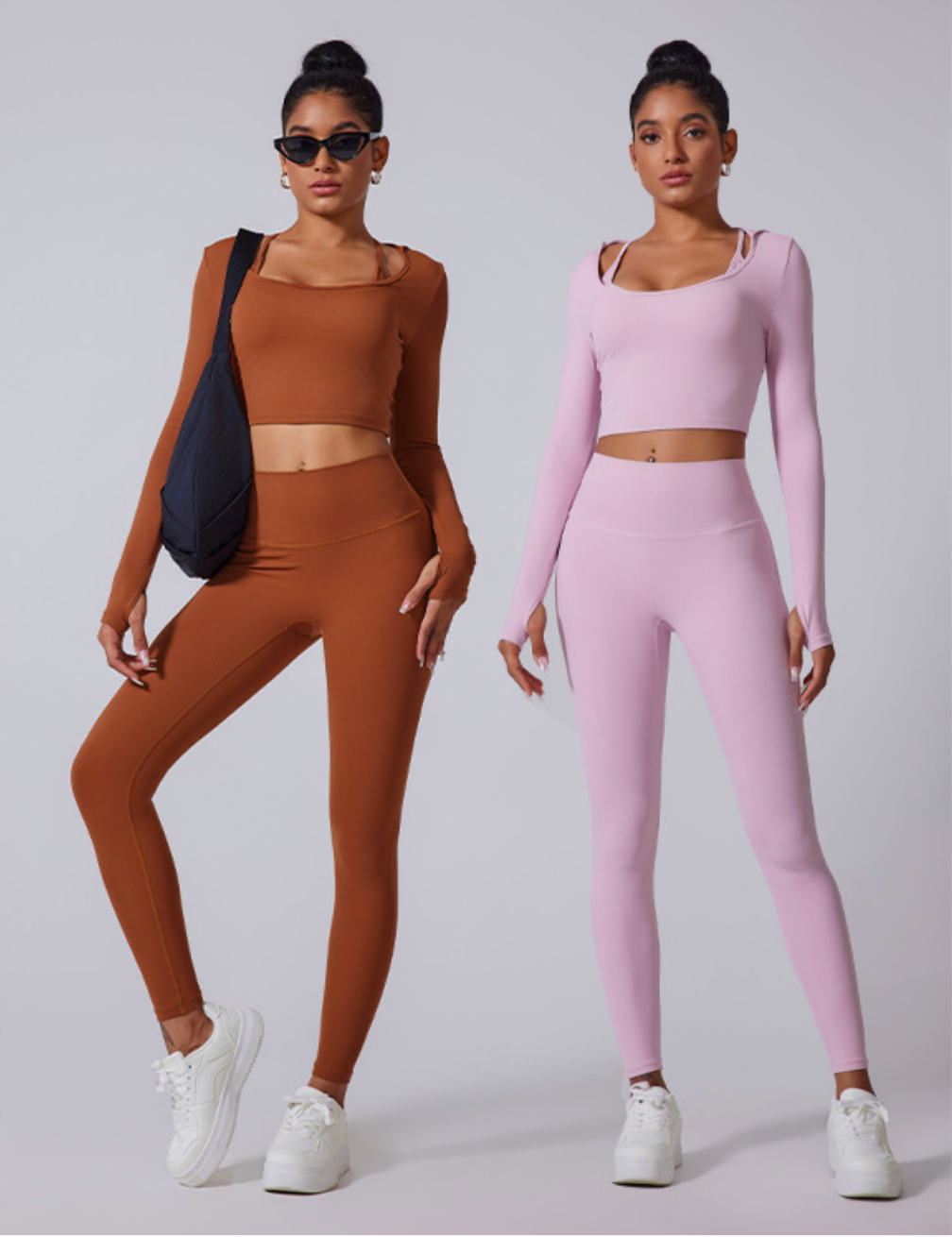 Two identical models standing side by side wearing matching workout sets in caramel brown and lilac. Both wearing white platform sneakers against gray background