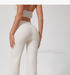 Back view of model in cream workout set, high-waist pants with 'Cloud Soft Naked Feeling' text overlay, seamless design, cream top.