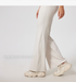 Side view of cream ribbed pants with wide legs, high waistband, 'Straight tube micro pull' text overlay, chunky cream sneakers