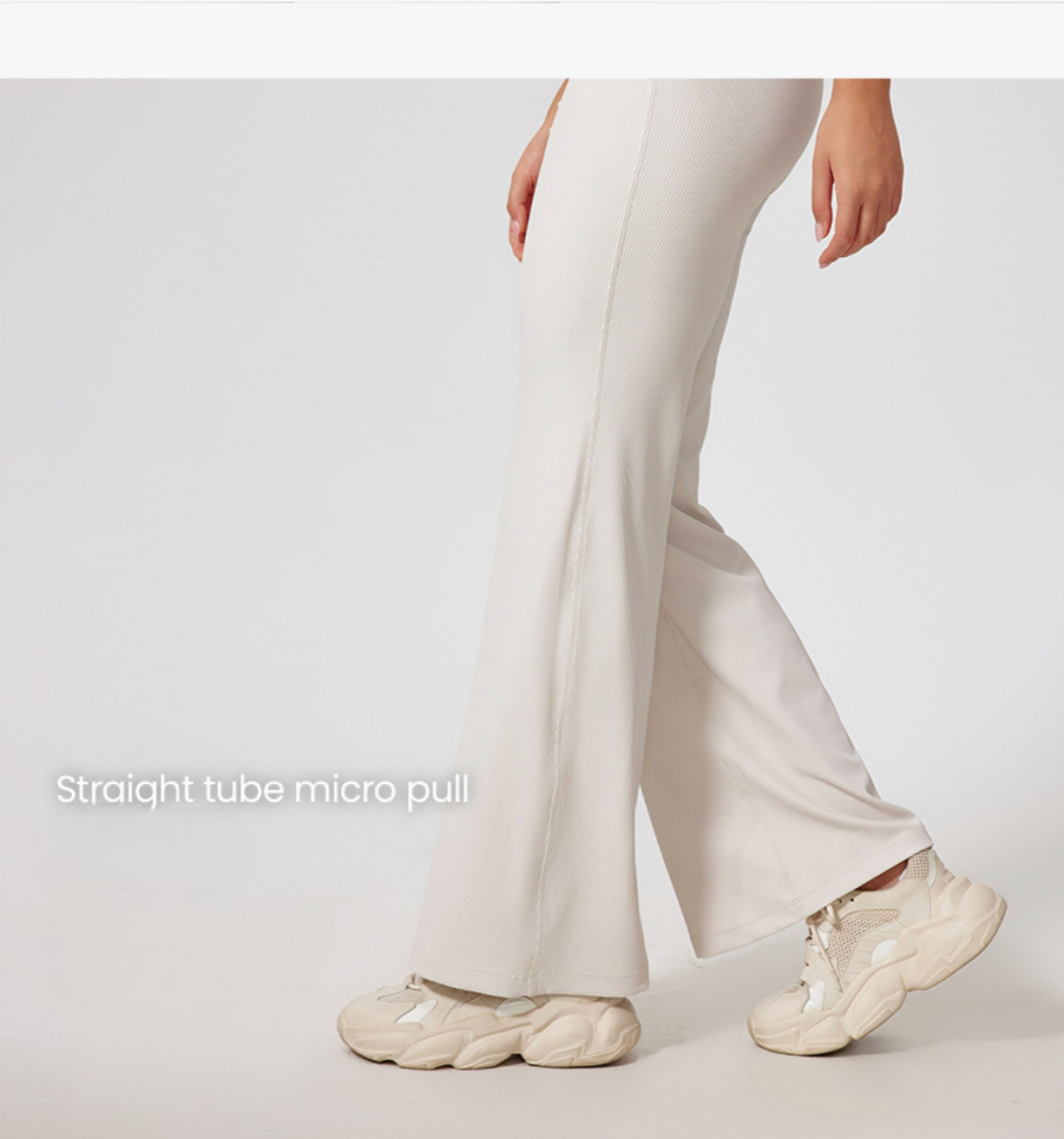 Side view of cream ribbed pants with wide legs, high waistband, 'Straight tube micro pull' text overlay, chunky cream sneakers