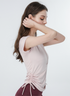 Pink side-ruched athletic tee with zipper neckline, model shown in profile with arms raised