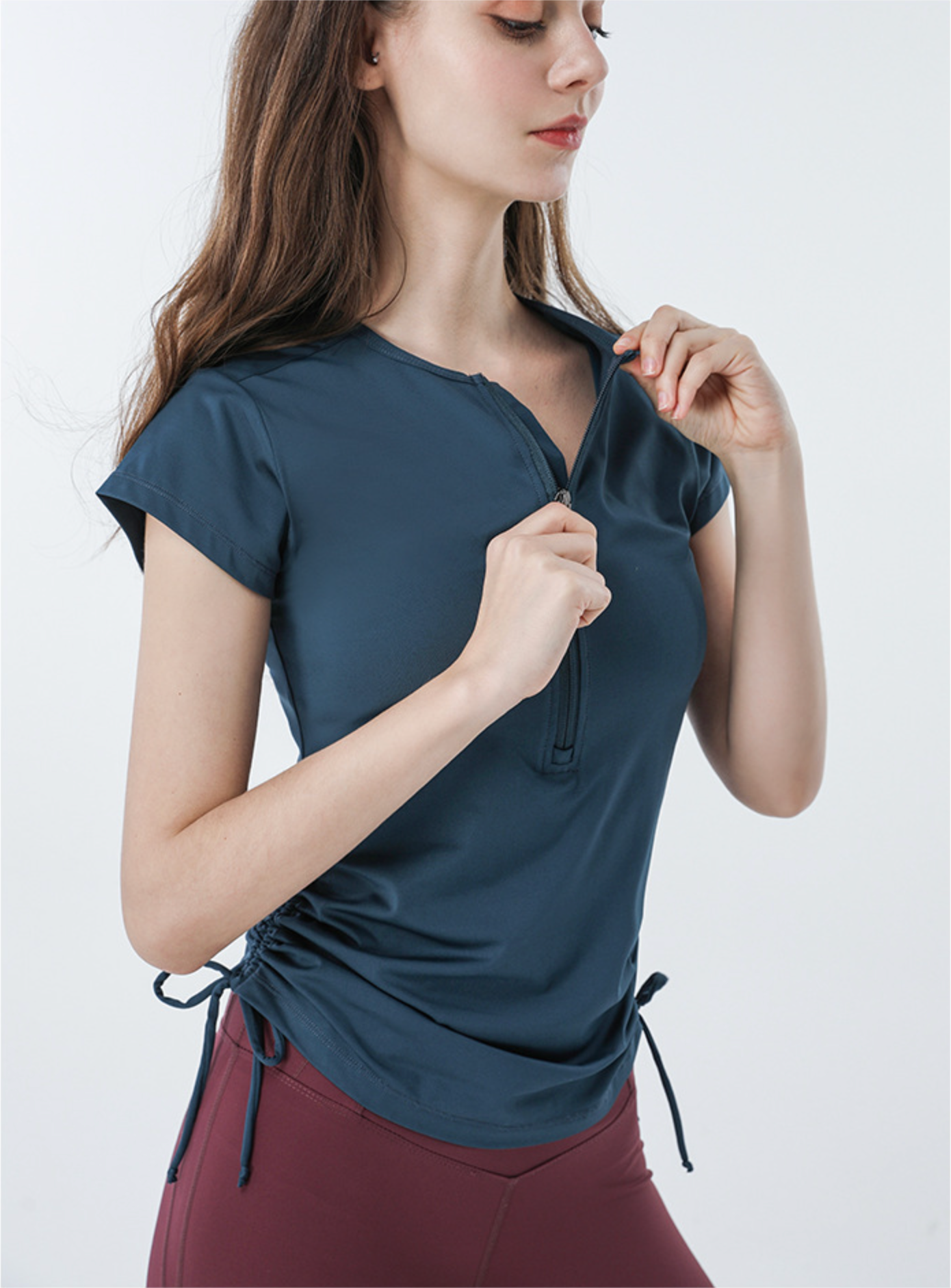 Navy short sleeve athletic tee with front zipper and side ties, worn with burgundy shorts