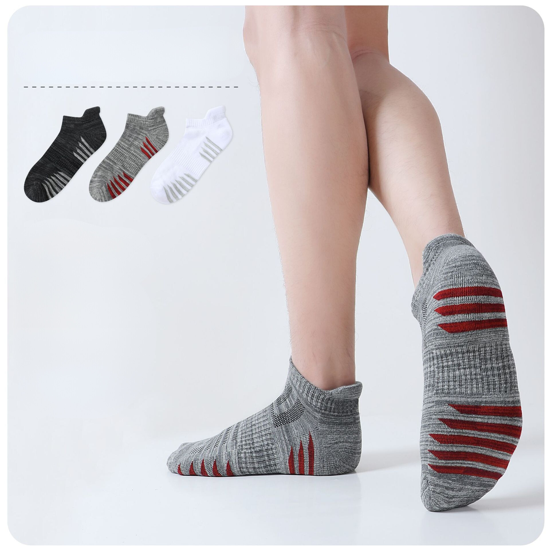 Athletic ankle socks with ergonomic cushioning and ventilation mesh, featuring gray melange knit with red stripe details and arch support