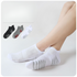 White mesh ankle socks with breathable ribbed texture and grey performance stripes, shown on model with arch compression