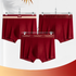 Three burgundy men's boxer briefs with different waistband styles hanging on display against white background