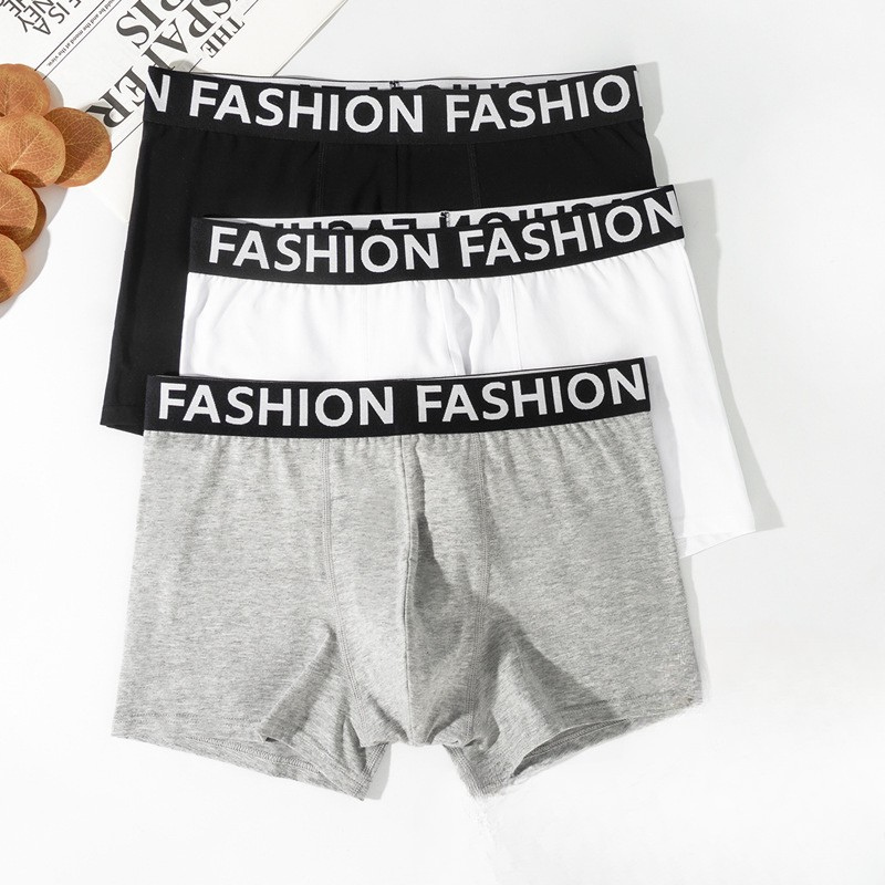 Set of three men's boxer briefs in black, white and gray with matching "FASHION" logo waistbands displayed flat