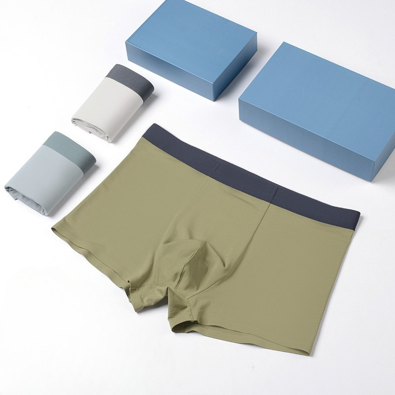 Premium men's underwear collection featuring boxers in olive, light gray and cream colors with blue gift boxes