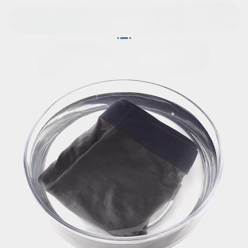Men's boxer briefs in glass bowl demonstrating water-resistant fabric technology and quick-dry propertie