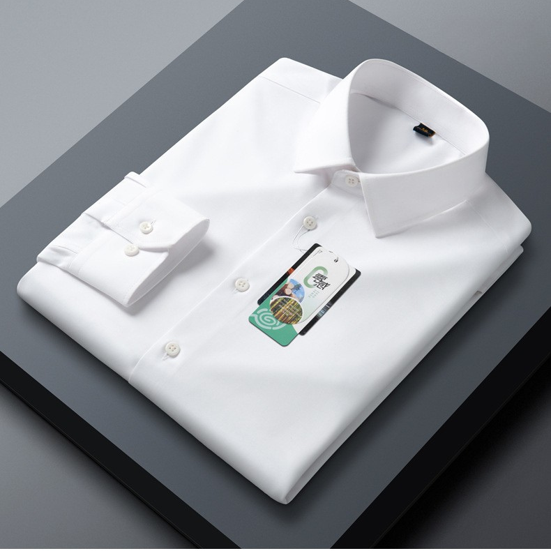 A folded sky blue dress shirt displayed on dark gray surface. Perfect collar fold showing with sleeve and buttons visible