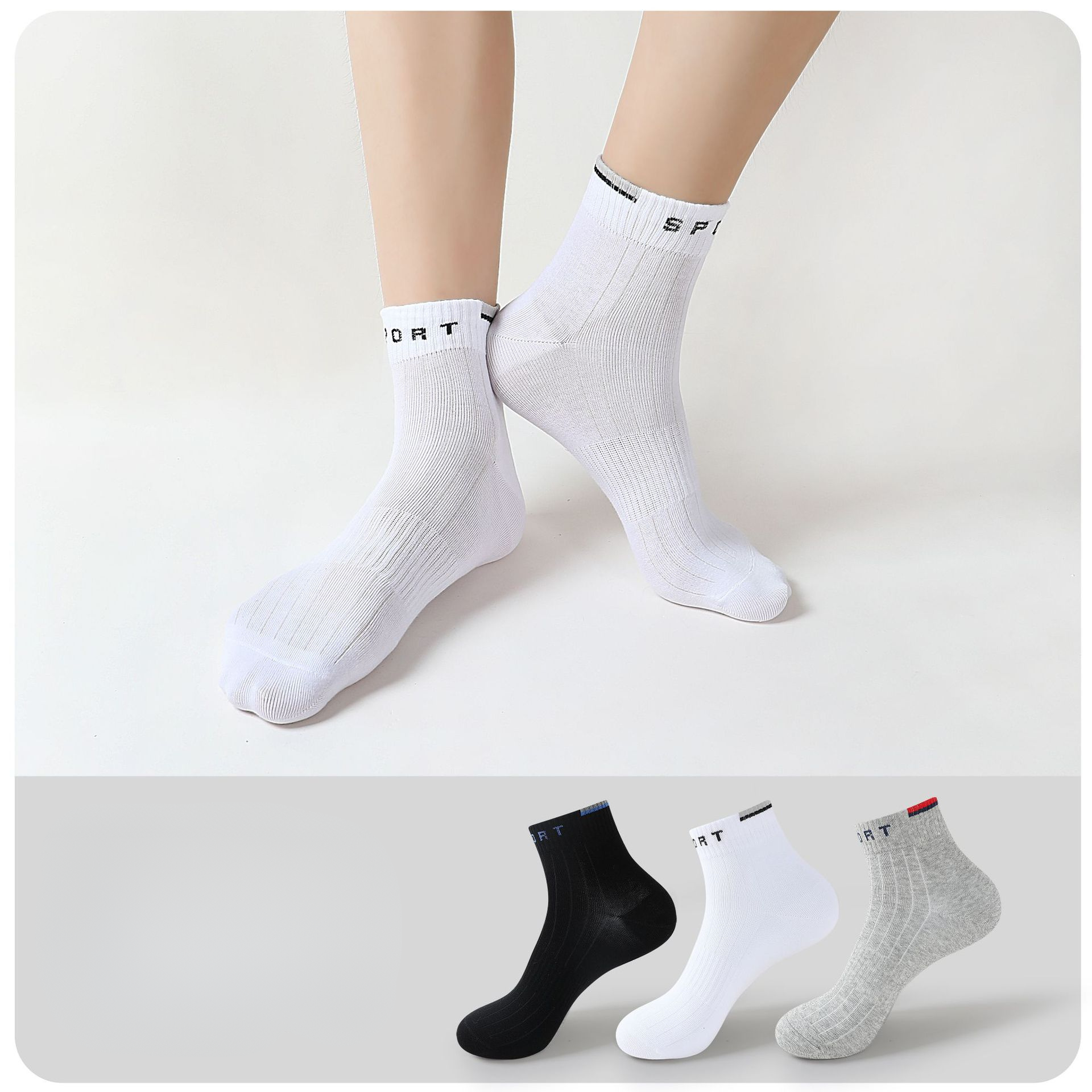 Person wearing white ankle socks with "SPORT" branding, paired with a display of black, white, and gray sock variations