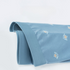 Close-up of blue boxer briefs fabric showing detailed crown pattern and premium texture