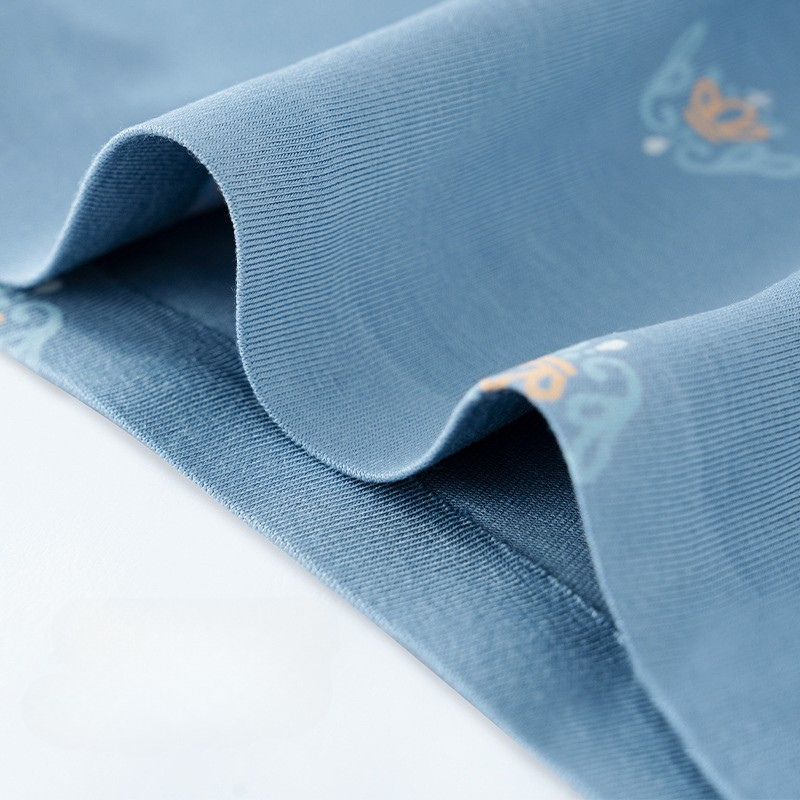 Detailed texture view of blue men's underwear fabric with delicate pattern print