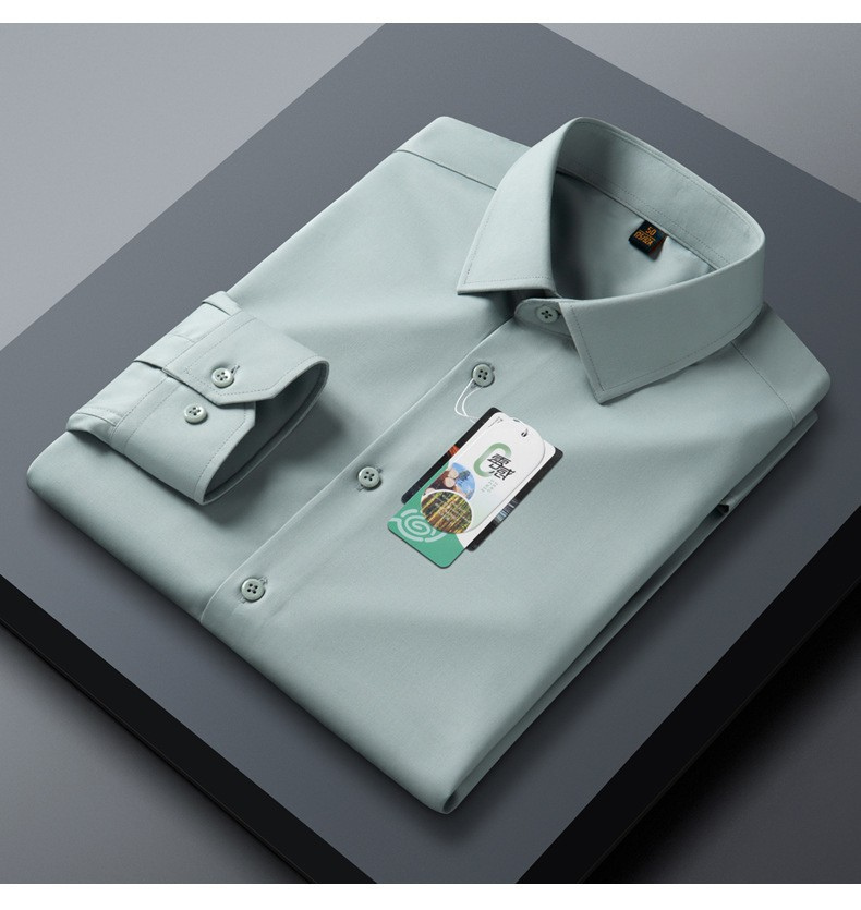 A folded mint green dress shirt displayed on dark gray surface. Clean collar lines with cuff detail and brand tag visible