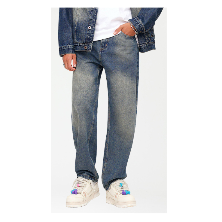A person wearing medium wash straight leg jeans with white t-shirt and denim jacket, paired with cream platform sneakers with colorful charms