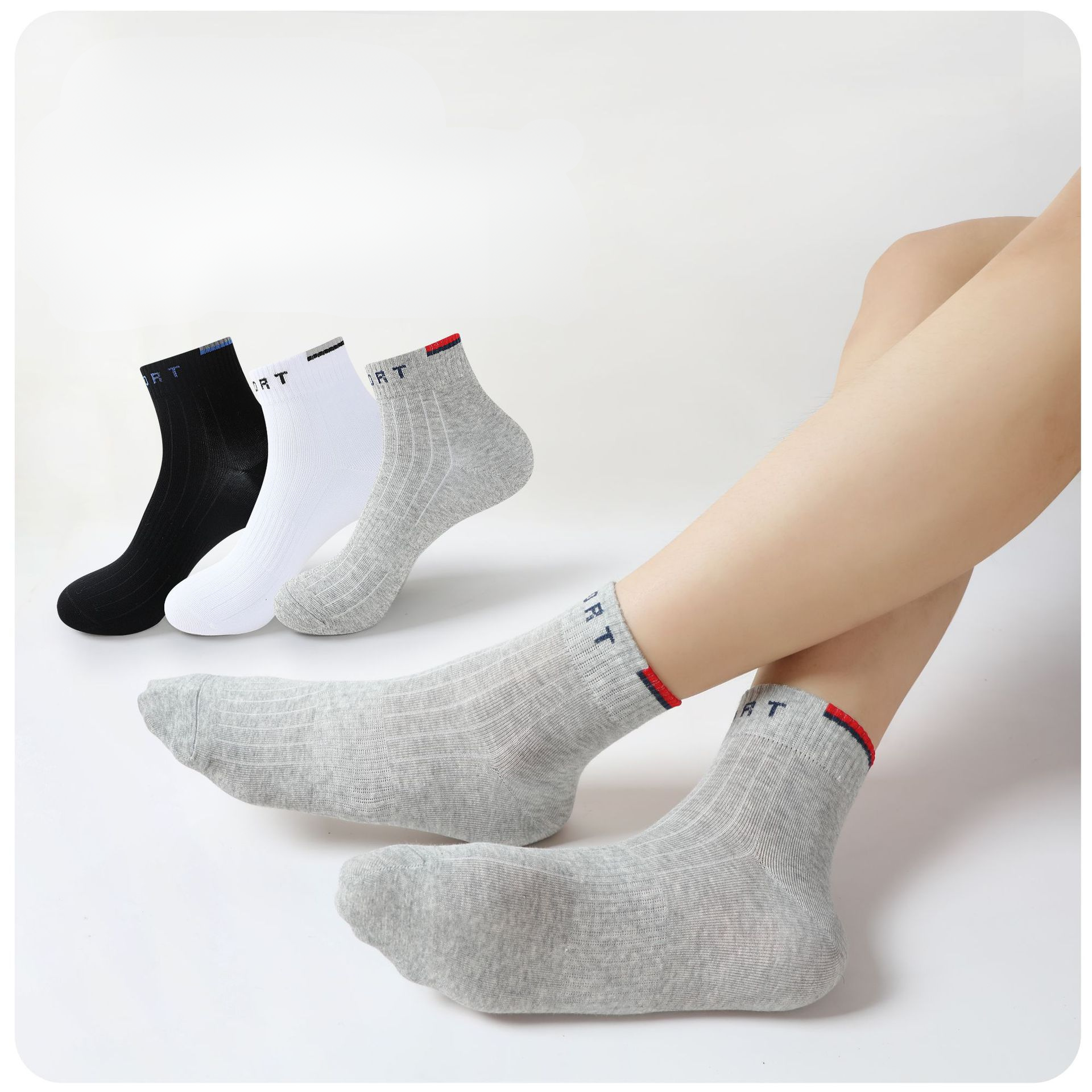 Person wearing gray ankle socks with "SPORT" branding, showing a close-up of the fit and ribbed texture