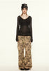 Front view of model wears black sheer ribbed off-shoulder top with camo cargo pants in Y2K streetwear look.