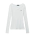 White sheer ribbed V-neck long sleeve top with raw-edge off-shoulder design in flat lay background.