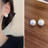 Pearl stud earring styling - model wearing earring and product shot on wood grain surface