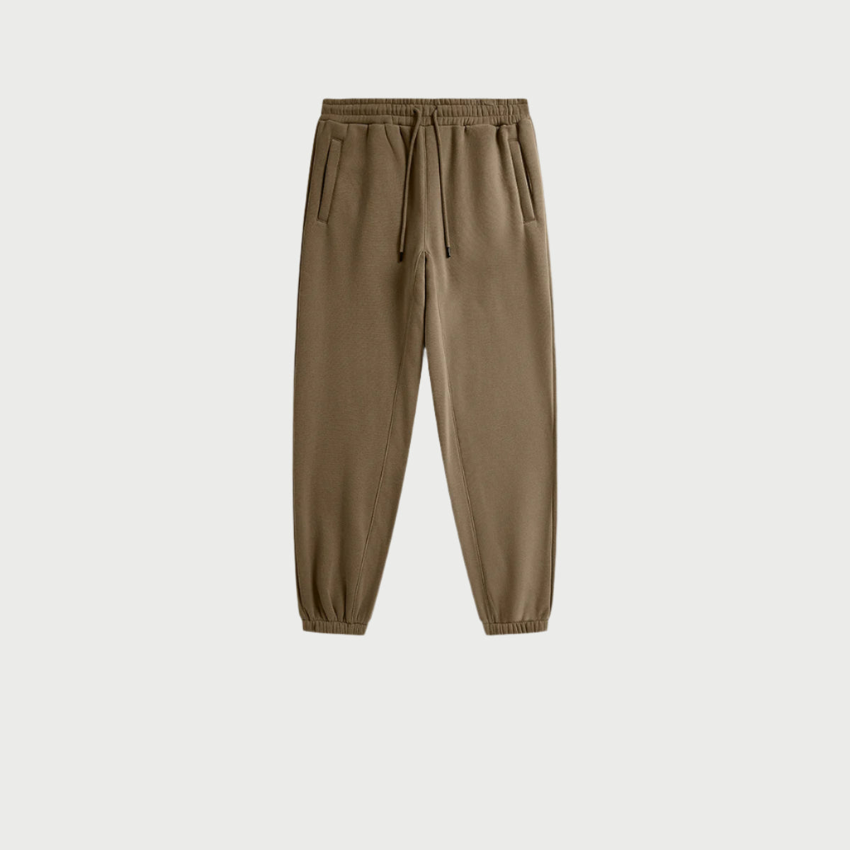 Close-up of olive green jogger sweatpants with elastic waistband and side pockets on white background