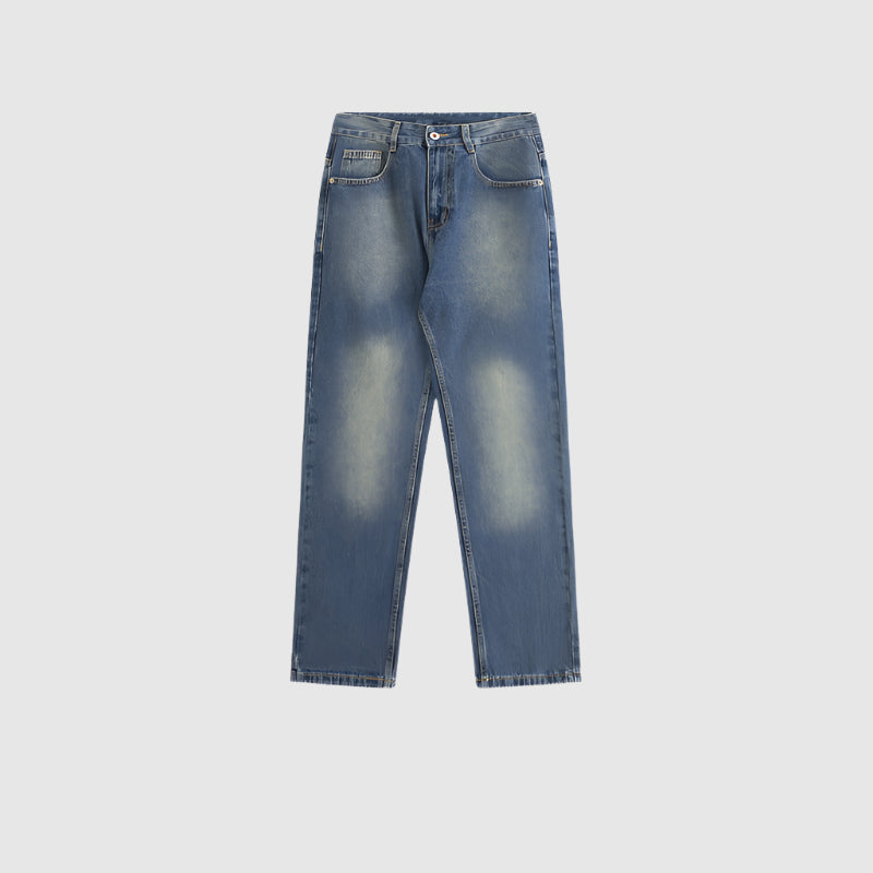 Straight leg medium wash denim jeans laid flat showing relaxed silhouette, five-pocket design and subtle fading pattern on light background