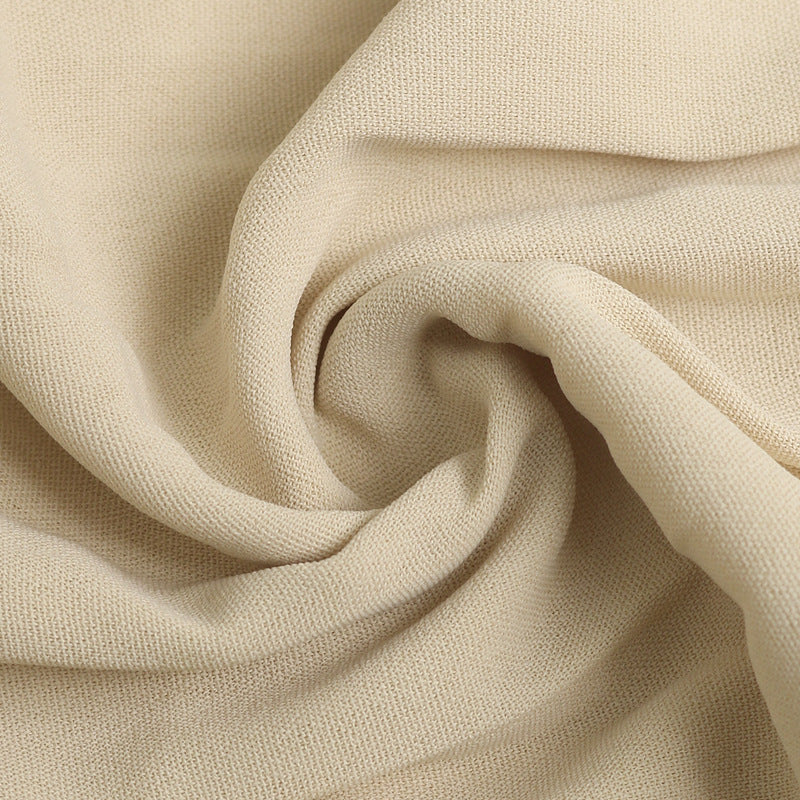 Close-up of cream fabric texture showing woven material detail for summer dress