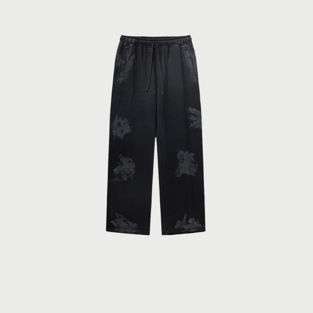 Black drawstring pants displayed flat with elasticized waistband and textured wash pattern. Shows relaxed straight-leg design