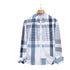 Blue and white plaid dress shirt on wooden hanger with button-down collar and mixed stripe pattern