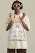 Man wearing cream apricot angel graphic tee with headphones and sunglasses