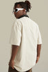Side view of man wearing angel tee and white sunglasses