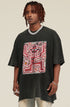 Angled view of black tee showing oversized fit and graffiti graphic.