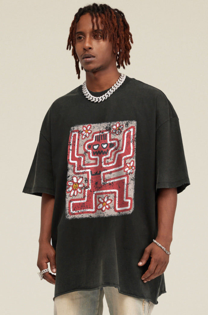 Angled view of black tee showing oversized fit and graffiti graphic.