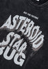 Angled close-up of graphic text on washed black tee.