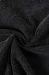 Twisted black tee fabric close-up showing soft cotton texture.