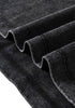 Folded fabric layers of black tee showcasing texture and edge stitching.

