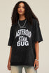 Back view of model wearing plain oversized black tee with relaxed fit and short sleeves.