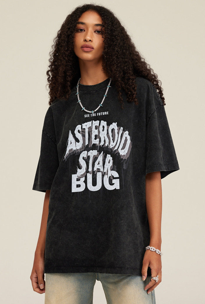 Back view of model wearing plain oversized black tee with relaxed fit and short sleeves.