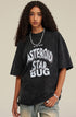 Close-up of model in oversized washed black tee with bold white graphic lettering.