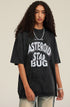 Model in streetwear pose, wearing oversized black tee and flared distressed jeans.
