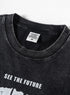 Close-up of collar and interior tag on black washed tee with streetwear branding.